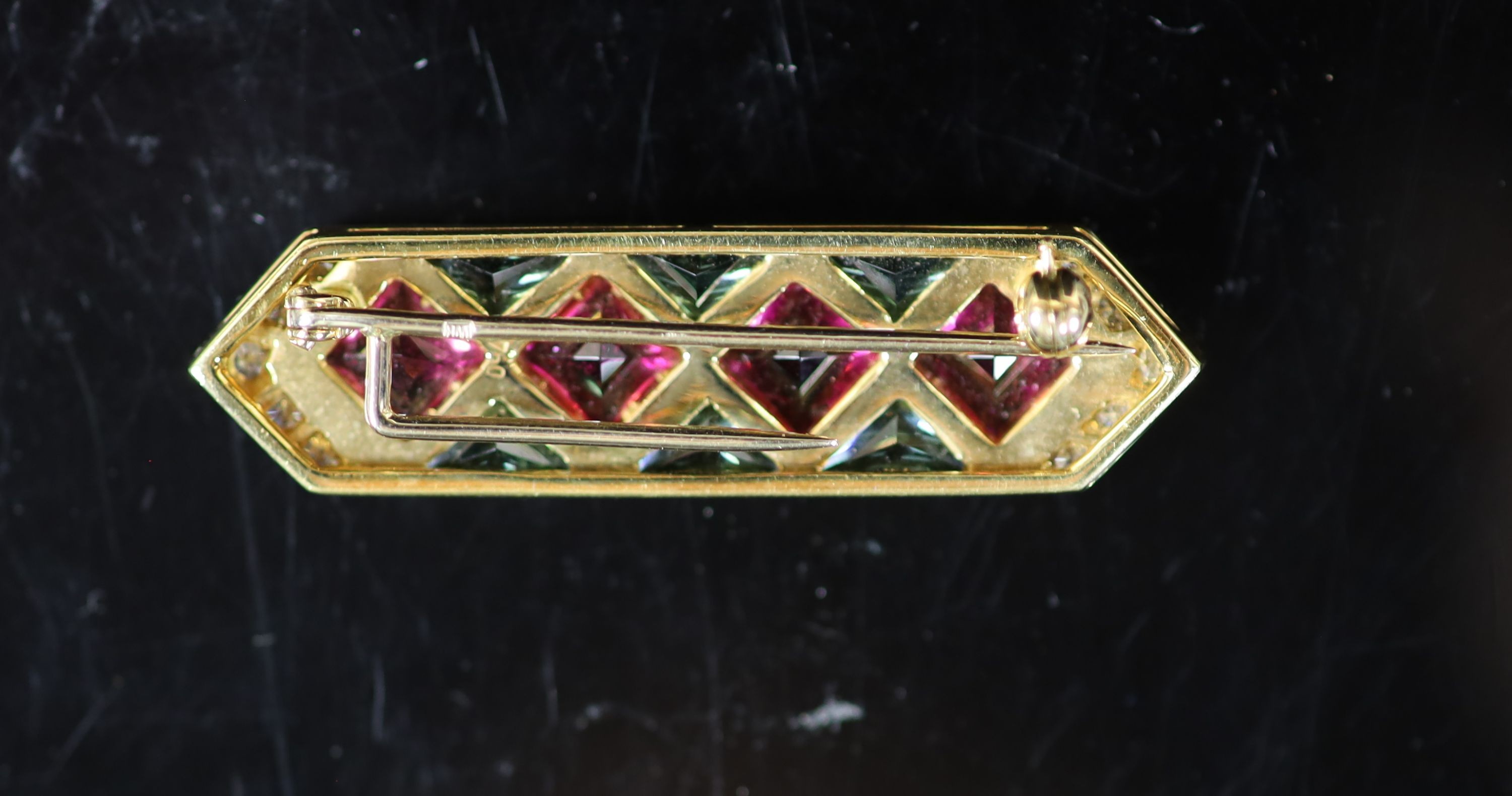 A 20th century Continental 18ct gold, two colour tourmaline? and diamond set bar brooch